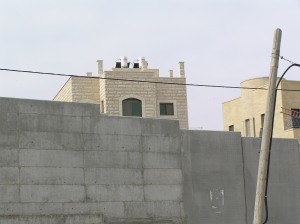 The Settlement houses peer over the wall, but Palestinian houses opposite have been demolished, leaving the families homeless.