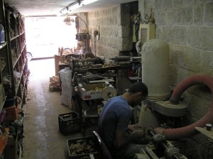 Making souvenirs from olive wood at the top of Milk Grotto